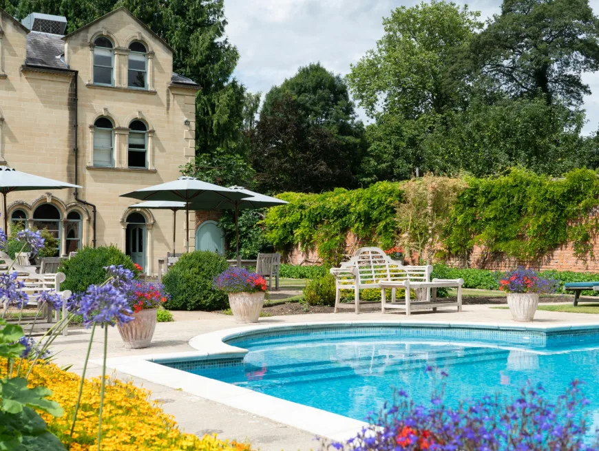 Bedroom with balcony and pool view