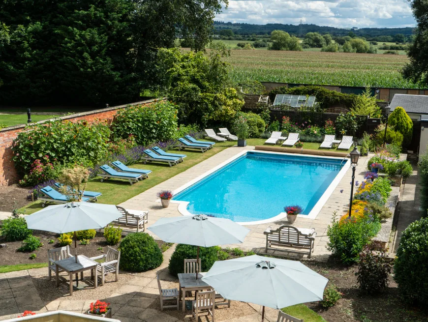Bedroom with balcony and pool view