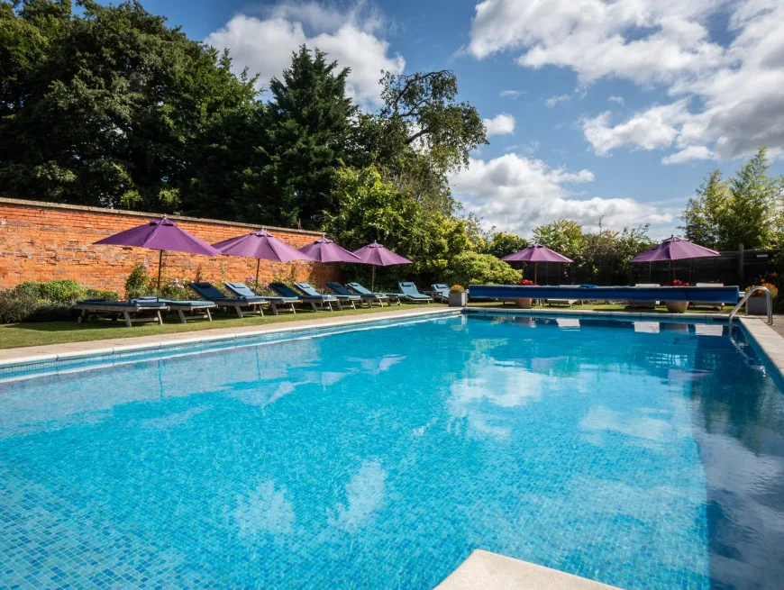 Bedroom with balcony and pool view