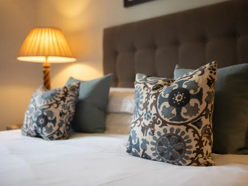 Bed with cushions and lamp